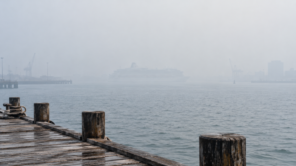 Haze Kembali Selimuti Labuan Bajo, BMKG Catat Jarak Pandang 4 Km 9 Fotografi lanskap pelabuhan yang memperlihatkan sebuah kapal feri di jarak menengah yang bentuknya mulai memudar dan menyatu dengan langit akibat partikel haze.